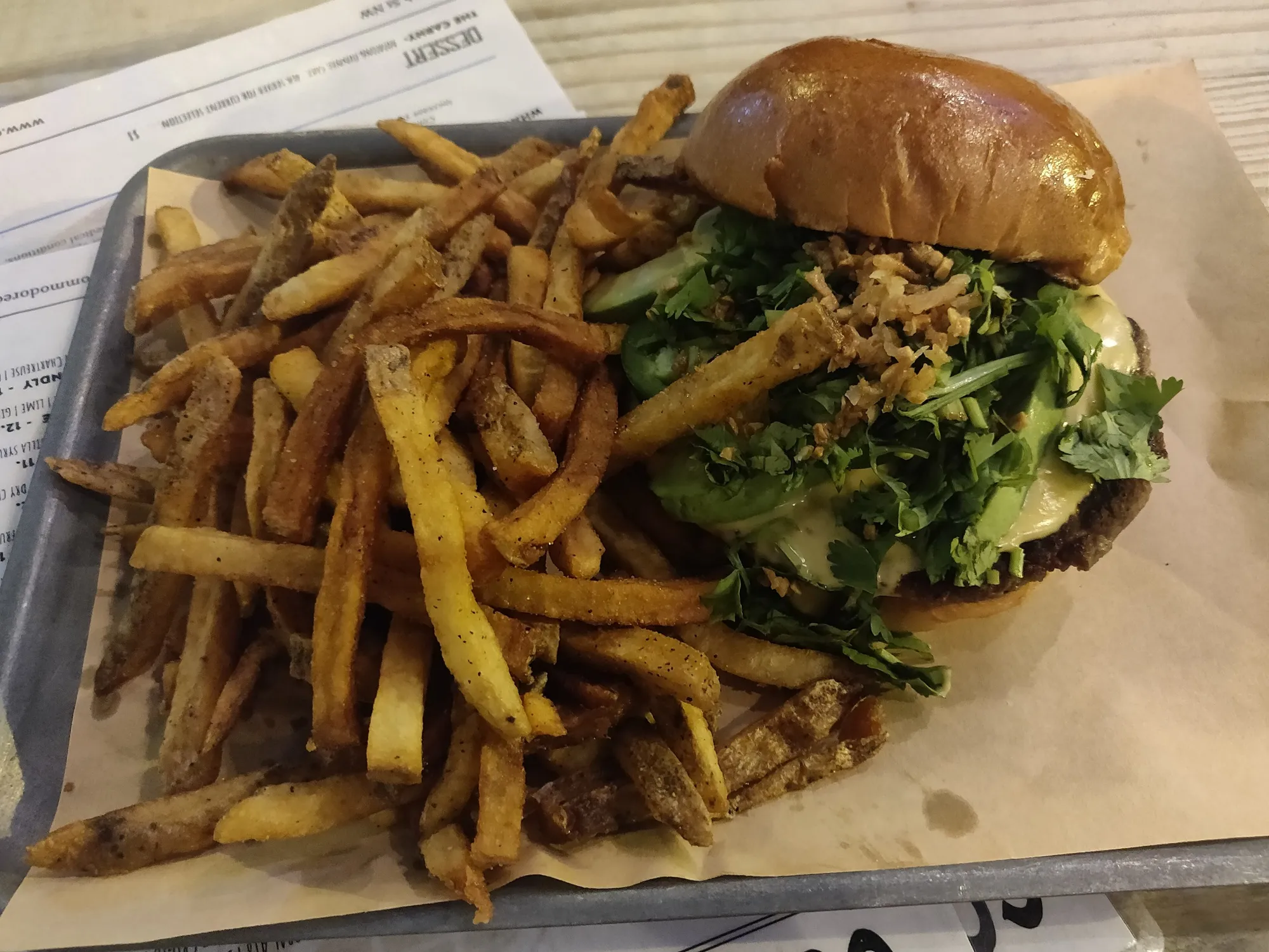 A cheeseburger and fries on a tray