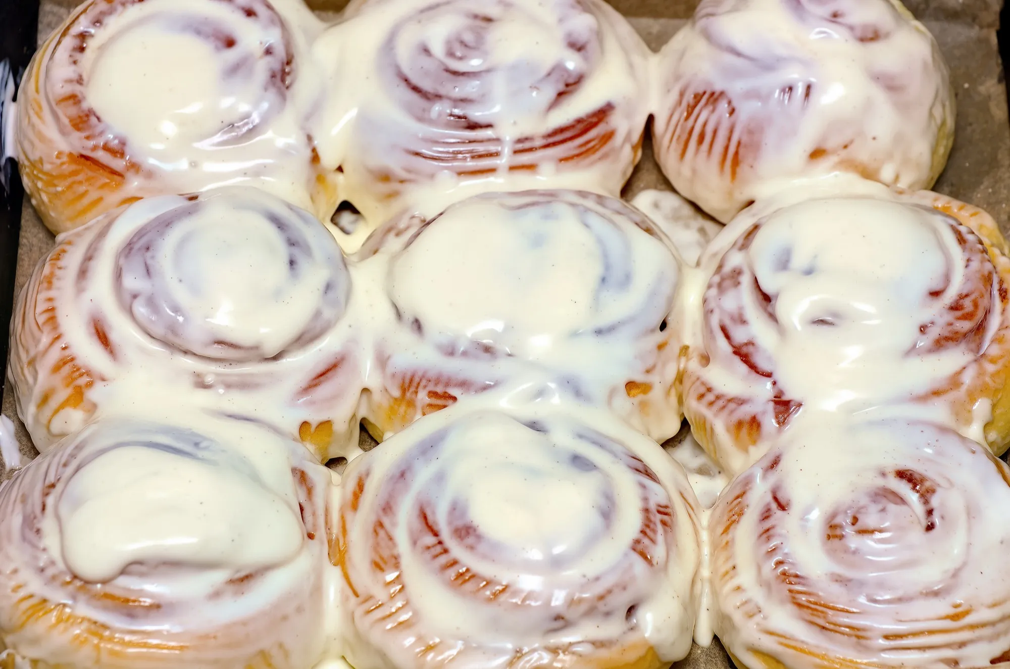 A tray of frosted cinnamon rolls