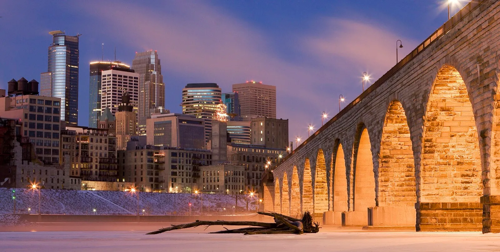 Downtown Minneapolis and the Stone Arch Bridge at dusk