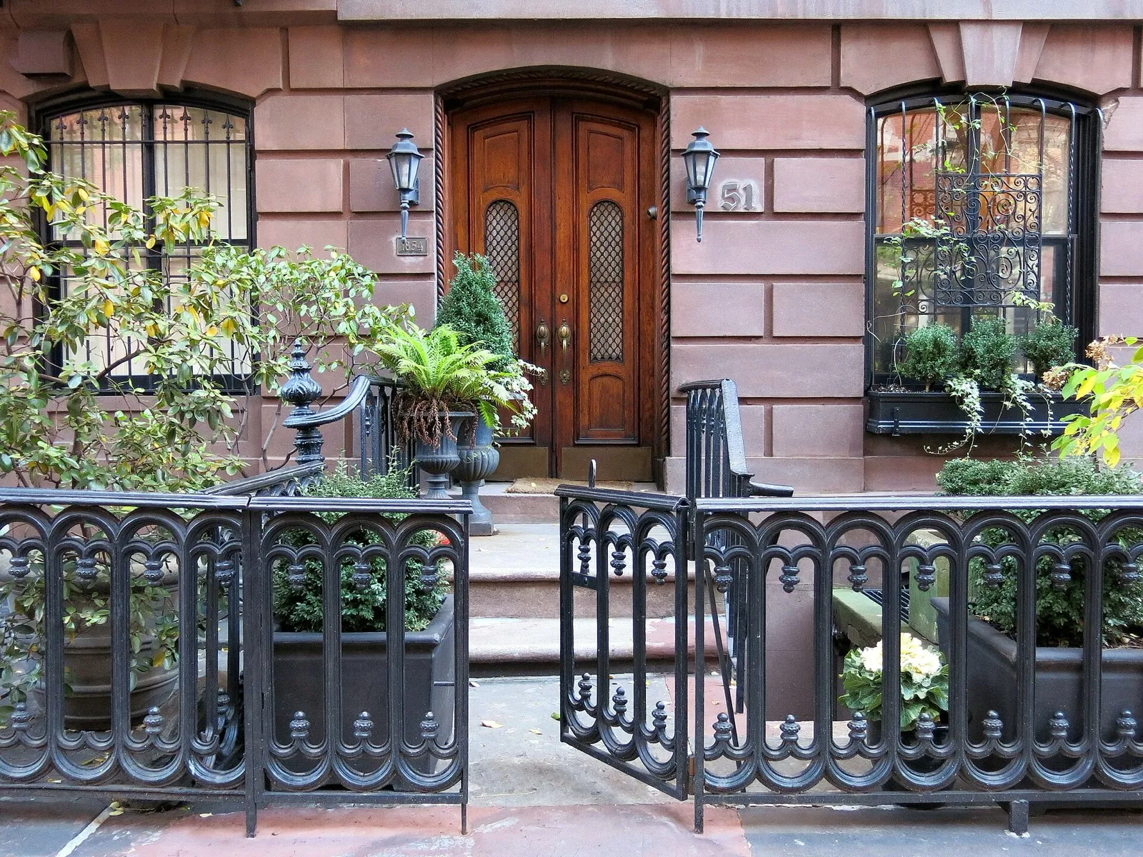 Brownstone entrance with wrought-iron fence in Greenwich Village, New York