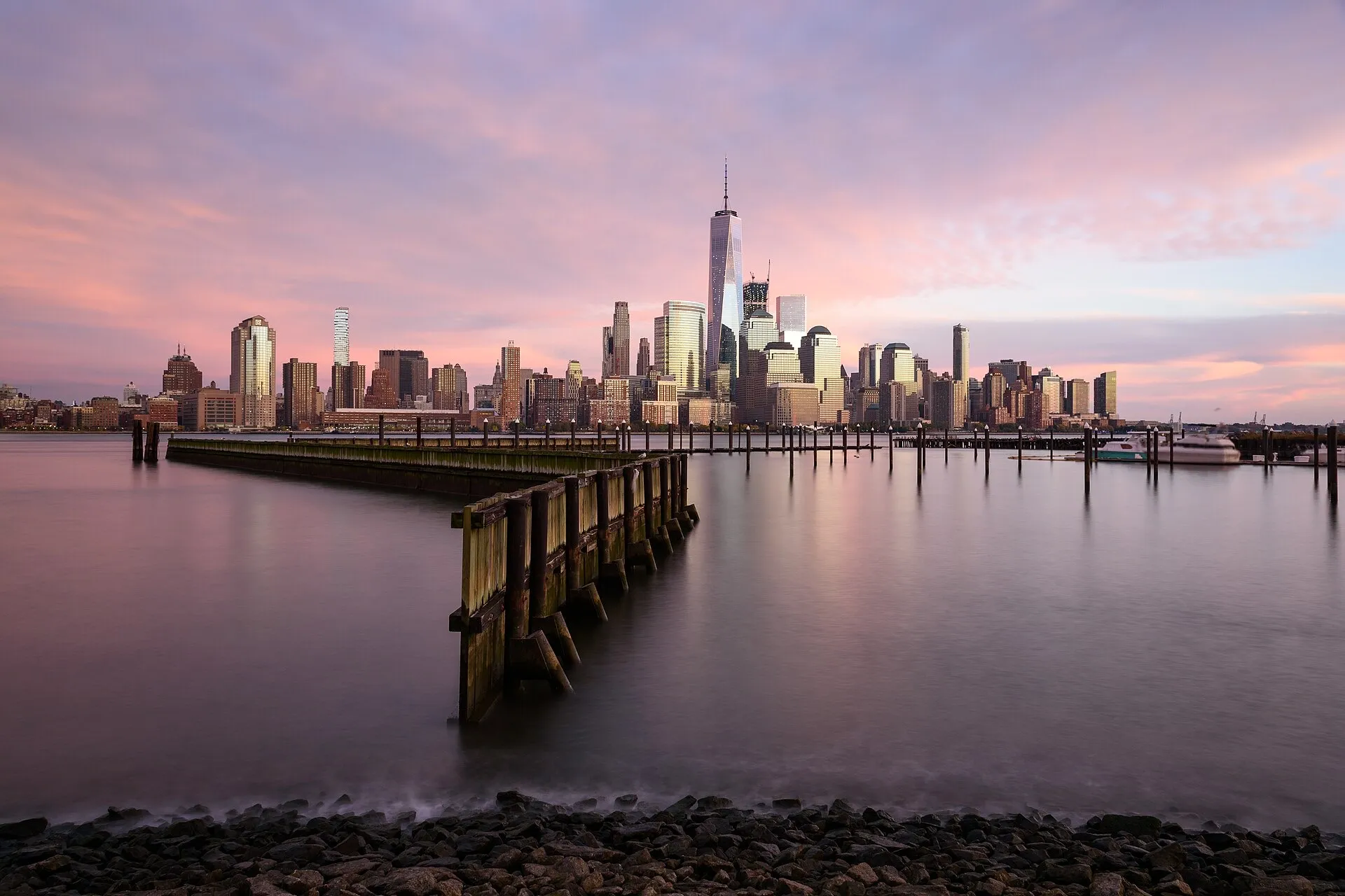 Lower Manhattan skyline at sunrise seen from across the Hudson River